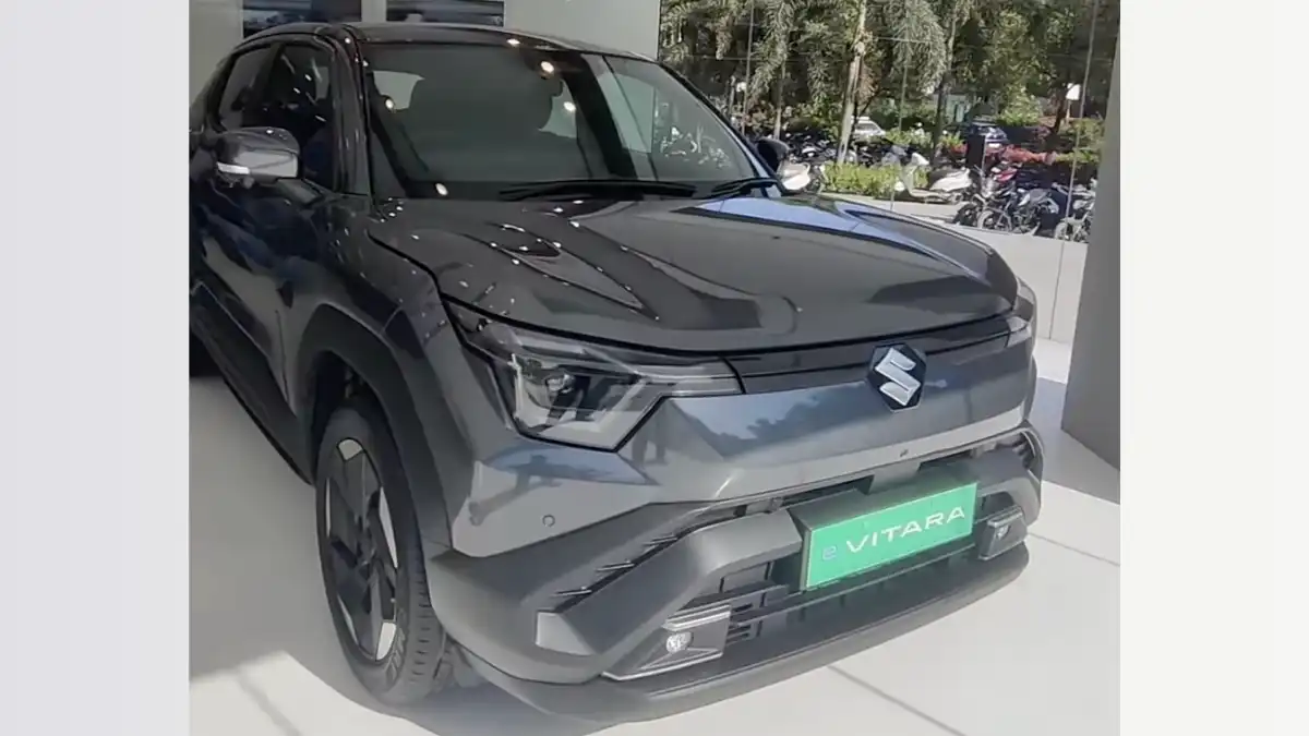 Maruti Suzuki e Vitara electric SUV in Land Breeze Green at launch event with ₹10.99 Lakh BaaS pricing display